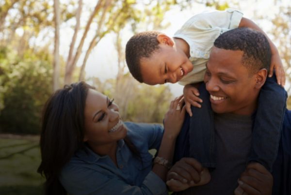 family of three playing outdoors