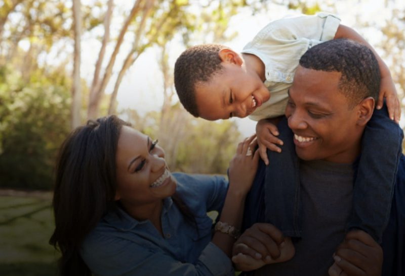 family of three playing outdoors