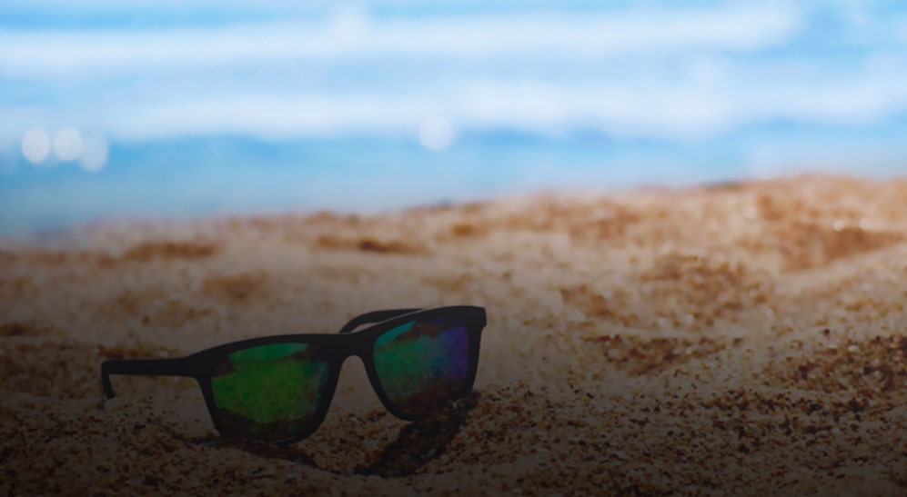 sunglasses on the the sand at the beach