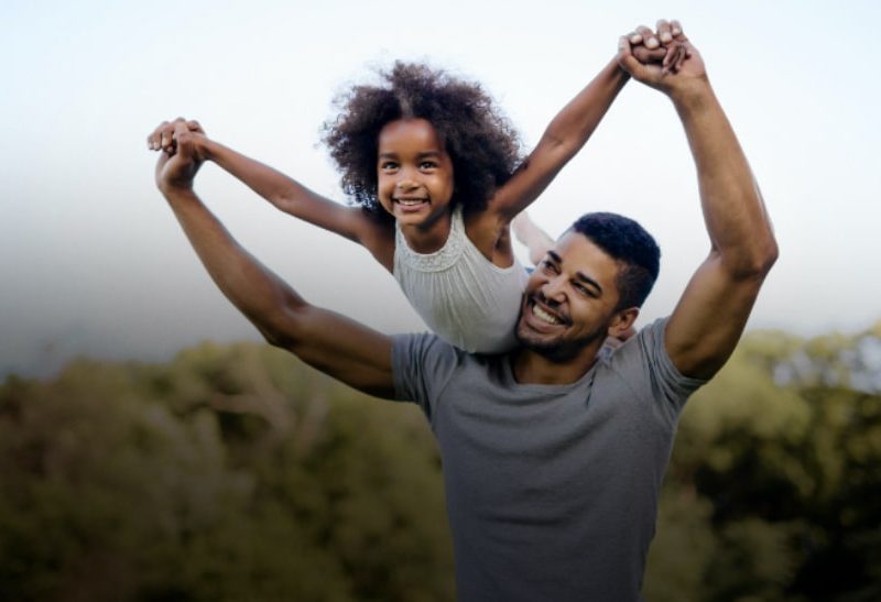 dad playing with daughter outdoors