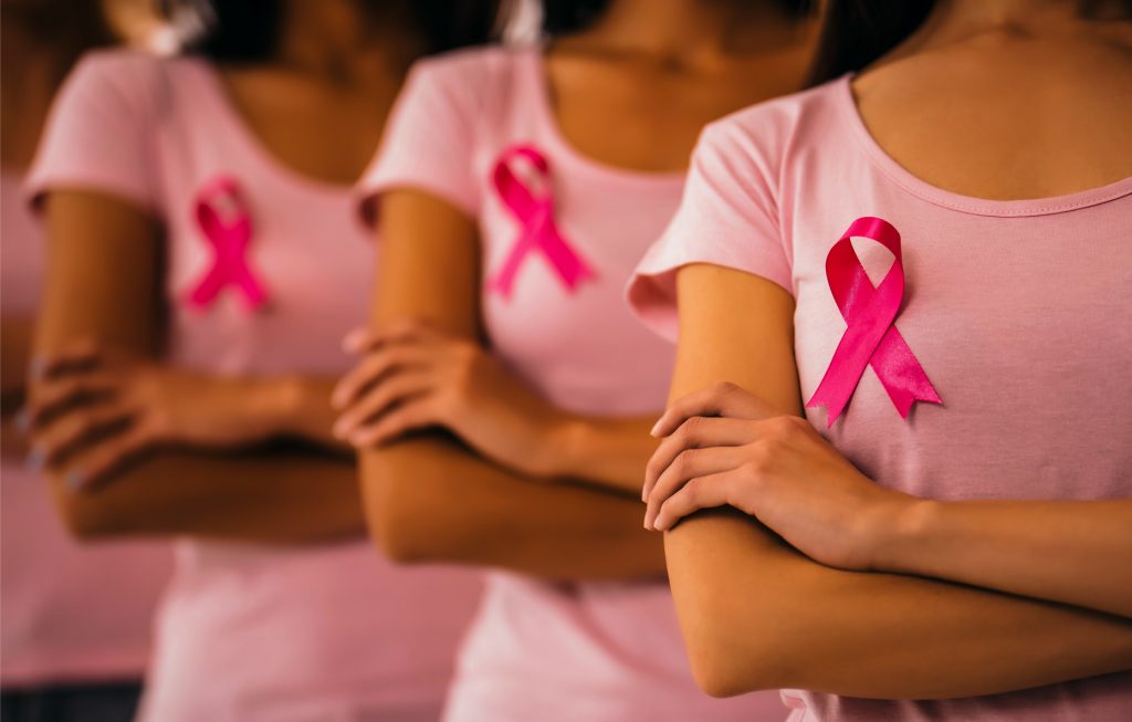 Beautiful ladies with arms crossed advocating for breast cancer campaign