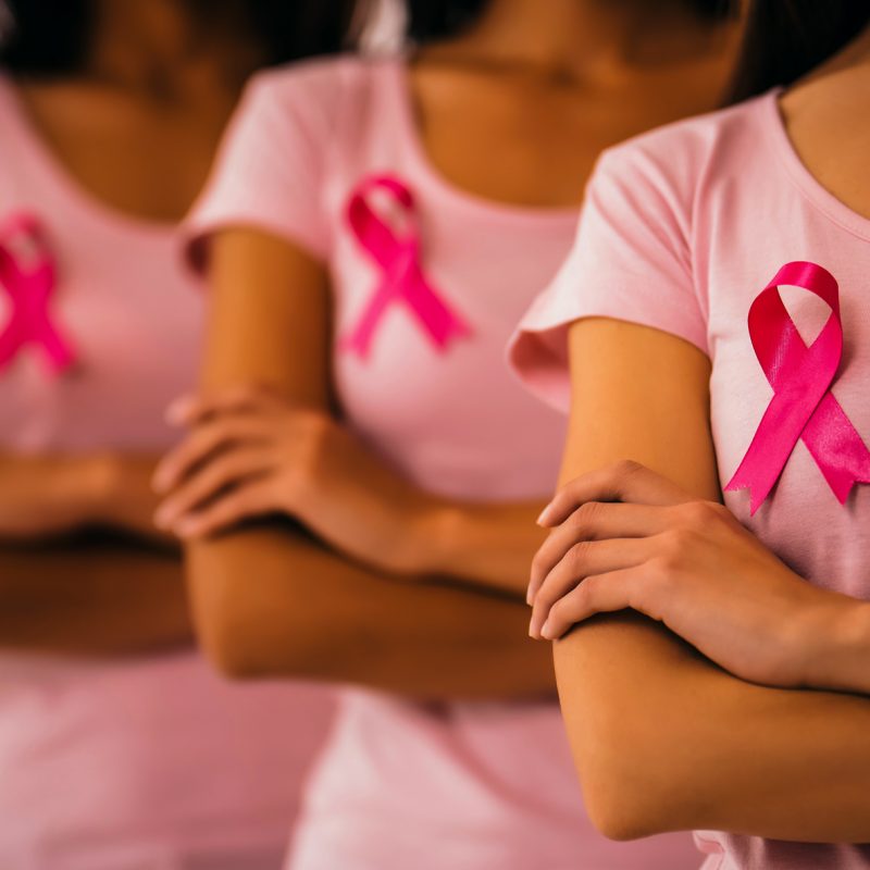 Beautiful ladies with arms crossed advocating for breast cancer campaign