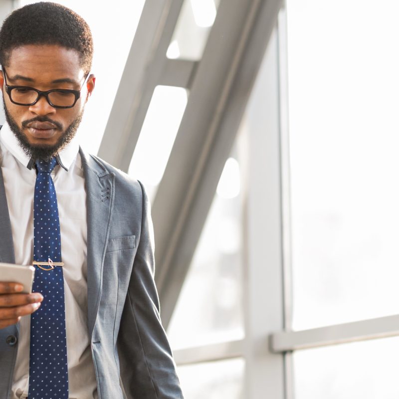 Gentleman on his phone all suited up in the office